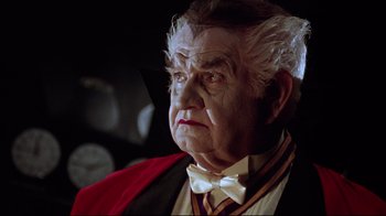 Movie still from “Gremlins 2: The New Batch” (1990), directed by Joe Dante – An old man with a white beard wearing a red and white tie; Close Up shot, Low angle