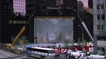 Movie still from “Gremlins 2: The New Batch” (1990), directed by Joe Dante – A stage with a large painting on the side of it; Extreme Wide shot, High angle