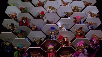 Movie still from “Gremlins 2: The New Batch” (1990), directed by Joe Dante – A group of people dressed up in costumes and hats; Extreme Wide shot, High angle