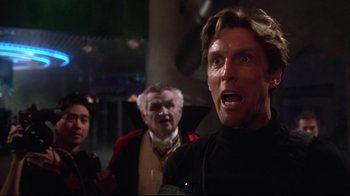 Movie still from “Gremlins 2: The New Batch” (1990), directed by Joe Dante – A group of men standing next to each other; Close Up shot, Low angle