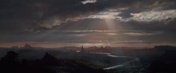 Movie still from “Greystoke: The Legend of Tarzan, Lord of the Apes” (1984), directed by Hugh Hudson – The sun is setting over a large city; Extreme Wide shot, High angle