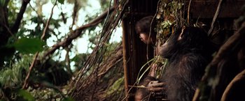 Movie still from “Greystoke: The Legend of Tarzan, Lord of the Apes” (1984), directed by Hugh Hudson – A young boy is standing next to a tree; Medium shot, Low angle