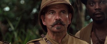 Movie still from “Greystoke: The Legend of Tarzan, Lord of the Apes” (1984), directed by Hugh Hudson – A man with a mustache wearing a hat and a uniform; Close Up shot, Low angle