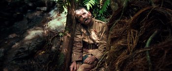 Movie still from “Greystoke: The Legend of Tarzan, Lord of the Apes” (1984), directed by Hugh Hudson – An old man in uniform sitting in a tree; Medium shot, High angle