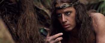 Movie still from “Greystoke: The Legend of Tarzan, Lord of the Apes” (1984), directed by Hugh Hudson – A person wearing a headband; Close Up shot, Over the shoulder angle