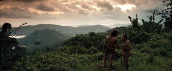 Movie still from “Greystoke: The Legend of Tarzan, Lord of the Apes” (1984), directed by Hugh Hudson – A man standing on top of a green hill; Extreme Wide shot, High angle