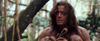 Movie still from “Greystoke: The Legend of Tarzan, Lord of the Apes” (1984), directed by Hugh Hudson – A person holding something in his hands; Close Up shot, Low angle