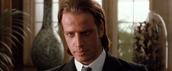 Movie still from “Greystoke: The Legend of Tarzan, Lord of the Apes” (1984), directed by Hugh Hudson – A man with long hair wearing a suit; Close Up shot, Low angle