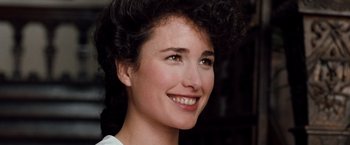 Movie still from “Greystoke: The Legend of Tarzan, Lord of the Apes” (1984), directed by Hugh Hudson – A person with curly hair smiling; Close Up shot, Over the shoulder angle