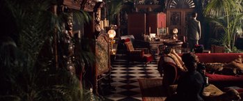 Movie still from “Greystoke: The Legend of Tarzan, Lord of the Apes” (1984), directed by Hugh Hudson – A living room filled with lots of furniture and decor; Wide shot, High angle