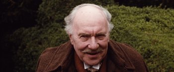 Movie still from “Greystoke: The Legend of Tarzan, Lord of the Apes” (1984), directed by Hugh Hudson – An older man with a mustache and a beard; Close Up shot, Low angle