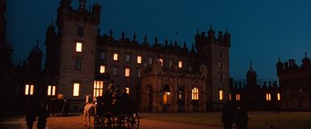 Movie still from “Greystoke: The Legend of Tarzan, Lord of the Apes” (1984), directed by Hugh Hudson – A horse drawn carriage in front of a large building at night; Extreme Wide shot, High angle