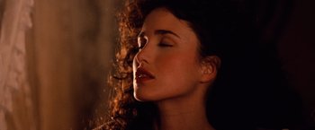 Movie still from “Greystoke: The Legend of Tarzan, Lord of the Apes” (1984), directed by Hugh Hudson – A woman with her eyes closed with her hair blowing in the wind; Close Up shot, Overhead angle