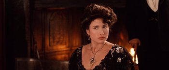 Movie still from “Greystoke: The Legend of Tarzan, Lord of the Apes” (1984), directed by Hugh Hudson – A woman in a black dress with a necklace; Close Up shot, Over the shoulder angle