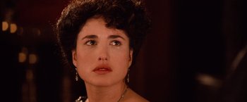 Movie still from “Greystoke: The Legend of Tarzan, Lord of the Apes” (1984), directed by Hugh Hudson – A person wearing a necklace; Close Up shot, Over the shoulder angle