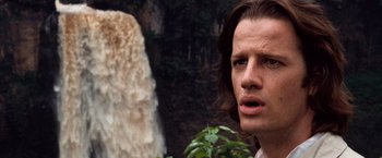 Movie still from “Greystoke: The Legend of Tarzan, Lord of the Apes” (1984), directed by Hugh Hudson – A person near a body of water; Close Up shot, Over the shoulder angle
