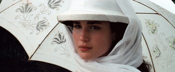 Movie still from “Greystoke: The Legend of Tarzan, Lord of the Apes” (1984), directed by Hugh Hudson – A person wearing a hat and holding an umbrella; Close Up shot, High angle