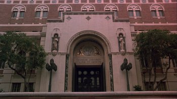 Movie still from “Gross Anatomy” (1989), directed by Thom Eberhardt – A building that has some statues on the front of it; Extreme Wide shot, Low angle