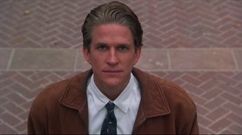Movie still from “Gross Anatomy” (1989), directed by Thom Eberhardt – A person wearing a jacket and tie; Close Up shot, High angle
