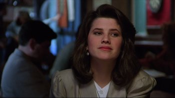 Movie still from “Gross Anatomy” (1989), directed by Thom Eberhardt – A person wearing a jacket; Close Up shot, Over the shoulder angle