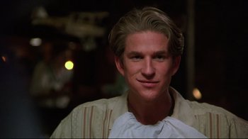 Movie still from “Gross Anatomy” (1989), directed by Thom Eberhardt – A man with blonde hair wearing a white shirt; Close Up shot, Low angle