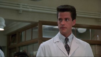 Movie still from “Gross Anatomy” (1989), directed by Thom Eberhardt – A person wearing a lab coat; Close Up shot, Low angle