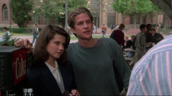 Movie still from “Gross Anatomy” (1989), directed by Thom Eberhardt – A man and a woman standing next to each other; Medium shot, Over the shoulder angle