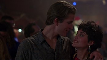 Movie still from “Gross Anatomy” (1989), directed by Thom Eberhardt – A man and a woman smiling at each other; Close Up shot, Low angle