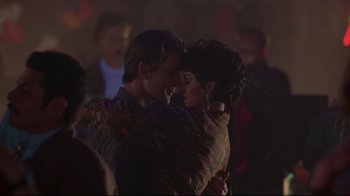 Movie still from “Gross Anatomy” (1989), directed by Thom Eberhardt – A man and a woman are hugging in a crowd; Close Up shot, Low angle