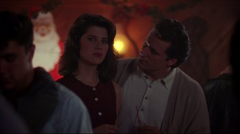 Movie still from “Gross Anatomy” (1989), directed by Thom Eberhardt – A man and a woman standing next to each other; Close Up shot, Over the shoulder angle