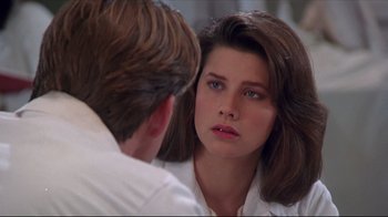 Movie still from “Gross Anatomy” (1989), directed by Thom Eberhardt – A woman looking at a man in the mirror; Close Up shot, Over the shoulder angle