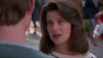 Movie still from “Gross Anatomy” (1989), directed by Thom Eberhardt – A young woman talking to a young man on the sidewalk; Close Up shot, Over the shoulder angle