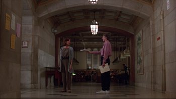 Movie still from “Gross Anatomy” (1989), directed by Thom Eberhardt – Two people are standing in an empty room; Wide shot, Low angle