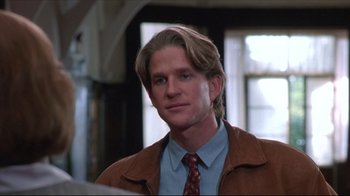 Movie still from “Gross Anatomy” (1989), directed by Thom Eberhardt – A person wearing a suit and tie; Close Up shot, Low angle