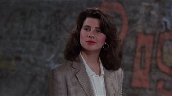 Movie still from “Gross Anatomy” (1989), directed by Thom Eberhardt – A woman in a jacket and a jacket with long hair; Close Up shot, Over the shoulder angle