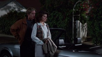 Movie still from “Gross Anatomy” (1989), directed by Thom Eberhardt – A man and a woman standing next to each other; Medium shot, Over the shoulder angle