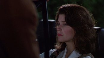 Movie still from “Gross Anatomy” (1989), directed by Thom Eberhardt – A person holding a umbrella; Close Up shot, Over the shoulder angle