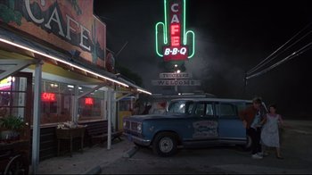 Movie still from “Gross Anatomy” (1989), directed by Thom Eberhardt – An old truck parked in front of a restaurant; Wide shot, High angle