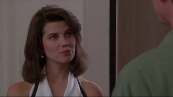 Movie still from “Gross Anatomy” (1989), directed by Thom Eberhardt – A person wearing a white shirt; Close Up shot, Over the shoulder angle