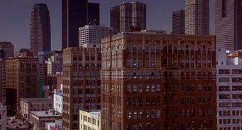 Movie still from “Grosse Pointe Blank” (1997), directed by George Armitage – A view of a city skyline from a distance; Extreme Wide shot, High angle