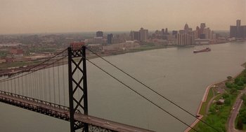Movie still from “Grosse Pointe Blank” (1997), directed by George Armitage – A view of a bridge and a city from a distance; Extreme Wide shot, High angle