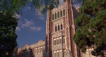 Movie still from “Grosse Pointe Blank” (1997), directed by George Armitage – A large building with many windows on a sunny day; Extreme Wide shot, Low angle