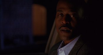 Movie still from “Grosse Pointe Blank” (1997), directed by George Armitage – A person in a car at night; Close Up shot, Low angle