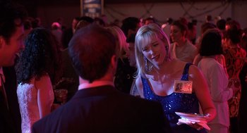 Movie still from “Grosse Pointe Blank” (1997), directed by George Armitage – A woman in a blue dress talking to a man in a black suit; Close Up shot, Over the shoulder angle