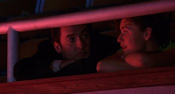 Movie still from “Grosse Pointe Blank” (1997), directed by George Armitage – A man and a woman looking at one another through a window; Close Up shot, Low angle