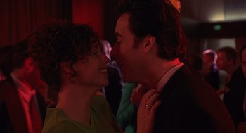 Movie still from “Grosse Pointe Blank” (1997), directed by George Armitage – A man and a woman kissing each other in a dark room; Close Up shot, Low angle