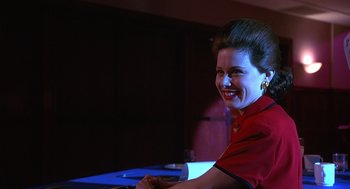 Movie still from “Grosse Pointe Blank” (1997), directed by George Armitage – A woman sitting in front of a computer keyboard; Close Up shot, Low angle