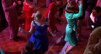 Movie still from “Grosse Pointe Blank” (1997), directed by George Armitage – A group of people dancing on a dance floor; Medium shot, Overhead angle