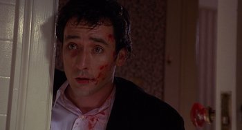 Movie still from “Grosse Pointe Blank” (1997), directed by George Armitage – A person with blood on his face; Close Up shot, Low angle