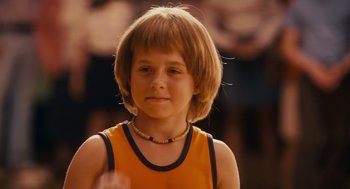 Movie still from “Grown Ups” (2010), directed by Dennis Dugan – A little girl wearing a yellow shirt and a necklace; Close Up shot, Low angle